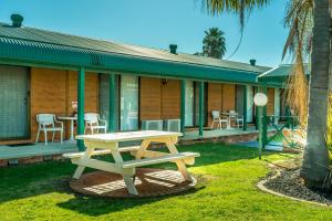 a picnic table in front of a house at Deniliquin Country Club Motor Inn in Deniliquin