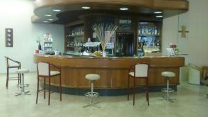 a bar with stools around it in a room at Hotel Terme Marconi in Montegrotto Terme