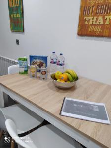 a table with a bowl of fruit and a bowl of milk at Casa de la Abuela en el Camino de Santiago a Finiesterre in Negreira