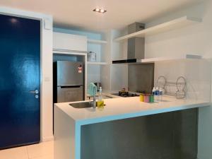 a kitchen with a sink and a refrigerator at FLYPOD - Blue Sky Apartment 4-5pax , Sutera Avenue in Kota Kinabalu