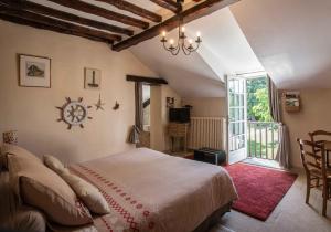 a bedroom with a large bed and a large window at Les pierres de Chevreuse in Chevreuse