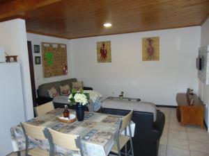 a living room with a table and a couch at Marques House in Machico