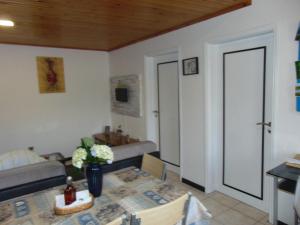 a living room with a table and a couch at Marques House in Machico