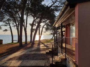 a porch of a house with a view of the ocean at Family Bungalow Pineta in Novigrad Istria