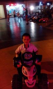 a man riding a toy four wheeler on the street at شاليهات بورتو مطروح فيو بحر Porto Matrouh Sea View Families Only in Marsa Matruh