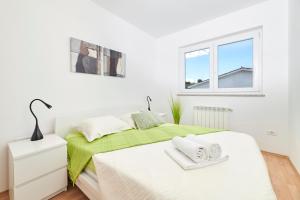 Postel nebo postele na pokoji v ubytování Villa Perla