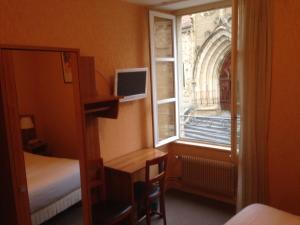 Postel nebo postele na pokoji v ubytování Hotel De L'Abbaye