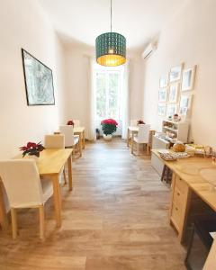 a dining room with tables and chairs and a large window at B&B Floridiana in Naples