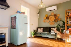 a living room with a couch and a refrigerator at La Casa Imperfetta in Treviso