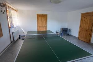 a ping pong table in the middle of a room at Glisne 69 in Mszana Dolna