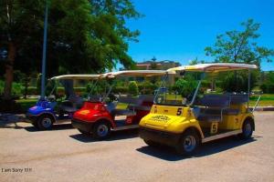a group of golf carts parked in a parking lot at Green Leaves Hotel in Dawwār Abū Duray‘ah ‘Abd al Karīm