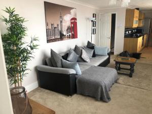 a living room with a couch and a table at Sea view apartment in Cleethorpes