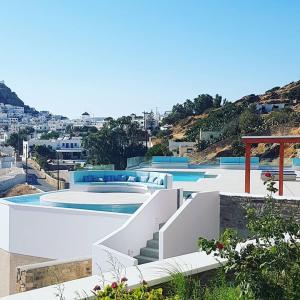 a building with a swimming pool and stairs next to it at Ios Sea View in Ios Chora