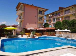a large swimming pool in front of a building at Курортно студио in Sunny Beach