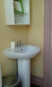 a bathroom with a white sink and a mirror at Helocar in Morlaix