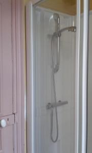 a shower with a shower head in a bathroom at Helocar in Morlaix