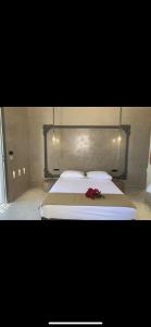 a bedroom with a bed with a flower on it at Blue Sky in Ios Chora