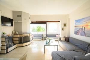 sala de estar con sofá y mesa en Calma Luxury Apartments #1 Sozopoli in Halkidiki, en Sozopoli