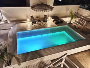 a swimming pool in the middle of a house at Playa del Mar - Adults Only in Monopoli