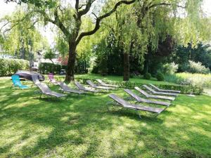 
a park filled with lots of green lawn chairs at Iris Porsche Hotel & Restaurant in Mondsee
