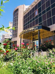 a building with a lot of flowers in front of it at Golden Palace in Aktau