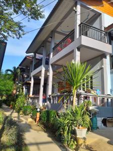 a building with a lot of plants in front of it at Tamarind Twin Resort in Ko Lanta