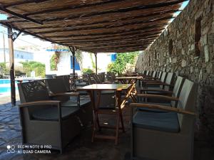 een rij tafels en stoelen in een openluchtrestaurant bij Akti Miaouli Holiday Home in Vári