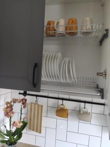 a kitchen with plates and utensils on a shelf at Potal in Kremenchuk