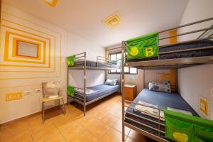 a room with two bunk beds and a room with at La Tortuga Hostel in Adeje