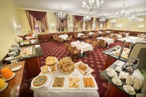 a restaurant with tables with food on them at Zvon Design Suites in České Budějovice