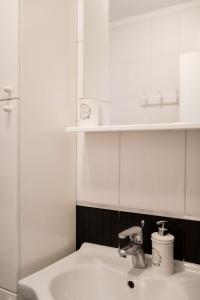 a white sink in a bathroom with a shelf at Apartment Teatar in Korčula