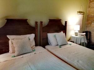 a bedroom with two beds with white pillows at Quinta da Mata - Turismo de Habitação in Chaves