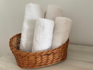 a basket filled with white toilet paper on a counter at Home away - Chic and Cozy Apartment in Constanţa