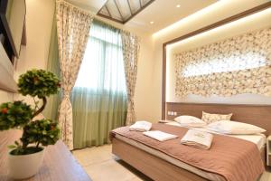 a bedroom with a bed with a large window at On Board Luxury Studios in Sarti
