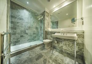 a bathroom with a tub, sink, and toilet at Golf View Hotel & Spa in Nairn