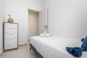 a bedroom with two beds and a dresser at Superb 1,5 BDR W balcony close to the beach in Tel Aviv