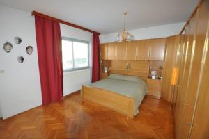 a bedroom with a bed and a window in it at Lux apartman LEO in Kostrena