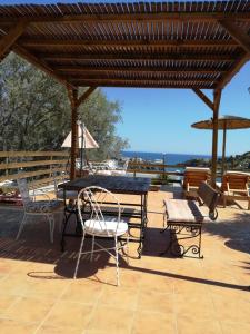 a picnic table and chairs on a patio at Oasis Hotel Loutro in Loutro
