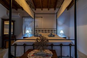 a bedroom with a large bed with a table at Kalavasos View Traditional Apartments in Kalavasos