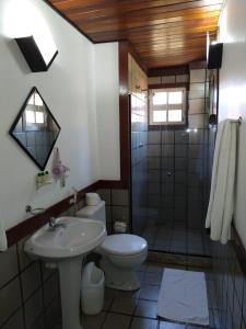 a bathroom with a sink and a toilet and a shower at Pousada Genesis in Arraial do Cabo +49 photos