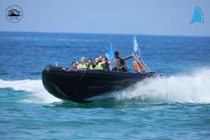 a group of people in a boat on the water at Stylish Garden Apartment Close to Akhziv Beach by Sea N' Rent in Nahariyya +28 photos