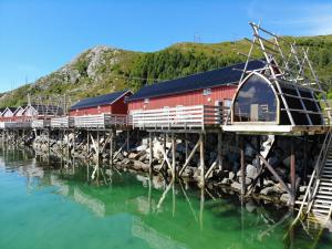 a train on a bridge over a body of water at Lofoten Basecamp in Leknes
