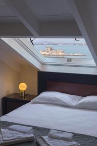 a bedroom with a large bed with a skylight at Pension Nikolaos in Nafplio