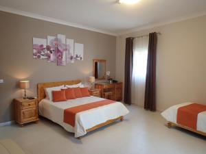 a bedroom with two beds and a mirror at Duncan Guesthouse in Marsaxlokk