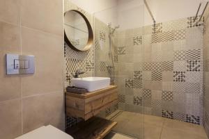 a bathroom with a sink and a mirror at White Vama Veche in Vama Veche