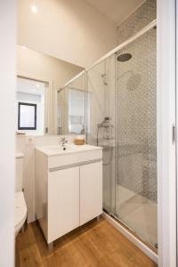 a bathroom with a white sink and a shower at MyTrip Porto in Matosinhos