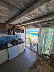a kitchen with a large window with a view of the ocean at Soqquadro Art&Relax - Spotorno (SV) Sea View in Spotorno