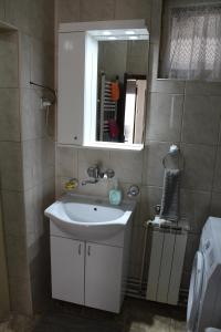 a bathroom with a white sink and a mirror at M apartment in Vršac +21 photos