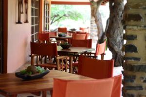 a row of tables and chairs in a restaurant at Ohange Namibia Lodge in Otavi