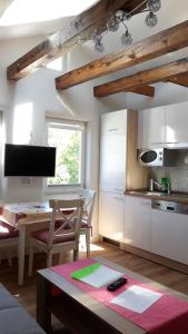 a kitchen with a table and a dining room at Haus Amelie in Bad Salzungen